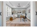 Bright office with ample natural light, built-in shelving, and a comfortable workspace for productivity and creativity at 6404 Fauvette Lane Ln, Holly Springs, NC 27540