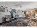 Spacious living room featuring a ceiling fan, carpeting, and traditional-style decor at 70 Fieldside Dr, Louisburg, NC 27549