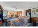 Open living room with carpeting, ceiling fan, and a comfortable seating area at 70 Fieldside Dr, Louisburg, NC 27549