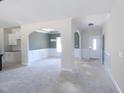Open-concept living room featuring arched doorways, wainscoting, and natural light at 802 Shade Tree Rd, Benson, NC 27504