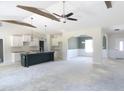 Open living space featuring vaulted ceilings, a kitchen island, and an adjacent dining area at 802 Shade Tree Rd, Benson, NC 27504