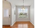 Bright dining area with hardwood floors, chandelier lighting, and large window at 9327 Falkwood Rd, Raleigh, NC 27617