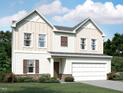 Charming two-story home with a two-car garage, complemented by beautiful landscaping at 956 Bombardier Ln, Spring Hope, NC 27882