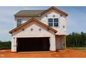 New construction home showing the framing stage, garage, and front entrance at 959 Bombardier Aly, Spring Hope, NC 27882