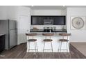 Modern kitchen features stainless steel appliances, granite countertops, and breakfast bar seating at 959 Bombardier Aly, Spring Hope, NC 27882