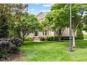 Spacious front yard featuring a well-manicured lawn and mature trees surrounding a beautiful brick home at 9603 Clubvalley Way, Raleigh, NC 27617
