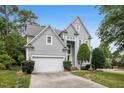 Inviting two-story home with lush landscaping, a two-car garage, and a charming front entrance at 100 Wentbridge Rd, Cary, NC 27519
