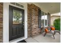 Close-up of the front door showing decorative glass, sidelights, and outdoor seating at 1024 Holland Bend Dr Dr, Cary, NC 27519