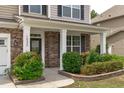 Inviting front porch featuring stone accents and lush landscaping at 1024 Holland Bend Dr Dr, Cary, NC 27519