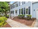 Well-maintained two-story home with a welcoming entryway, manicured landscaping, and a sidewalk at 104 S Crabtree Knl, Chapel Hill, NC 27514