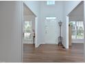 Bright foyer with light-colored walls, gleaming hardwood floors, and a coat rack near the front door at 1056 Evening Shade Ave, Rolesville, NC 27571
