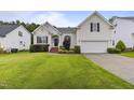 Charming home with manicured lawn, two-car garage, and beautiful landscaping at 107 Governors House Dr, Morrisville, NC 27560