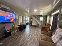 Bright living room featuring hardwood floors, a fireplace, and comfortable seating at 109 N 2Nd St, Sanford, NC 27330
