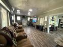 Spacious living room featuring hardwood floors, a fireplace, and comfortable seating at 109 N 2Nd St, Sanford, NC 27330