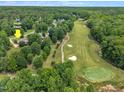 Aerial view of a home nestled near a beautiful golf course surrounded by lush green trees and greenery at 113 Feezor Ct, Clayton, NC 27527