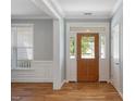 Inviting foyer with wood floors, elegant trim, and a front door with sidelights at 120 Tanager Farms Dr, Youngsville, NC 27596