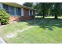 View of the front yard with stone pavers creating a walkway around the house at 1209 Landon St, Durham, NC 27703