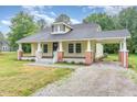 Inviting yellow home featuring a classic design and an attached carport on a gravel driveway at 1398 Tarboro Rd, Youngsville, NC 27596