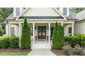 Charming front porch with classic columns and tasteful landscaping at 1412 Wakefield Farm Rd, Zebulon, NC 27597