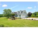 Well-maintained two story home boasts an attached garage and verdant landscaping at 14393 Nc Hwy 96 N, Zebulon, NC 27597