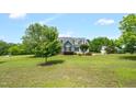 Sprawling lawn and mature trees surround this lovely two-story home with dormer windows at 14393 Nc Hwy 96 N, Zebulon, NC 27597