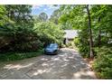 Long, private driveway leading to a home nestled among mature trees, offering seclusion and curb appeal at 16 Tottenham Ln # 16, Chapel Hill, NC 27517