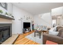 Bright living room featuring hardwood floors, a cozy fireplace, and neutral decor, creating an inviting atmosphere at 16 Tottenham Ln # 16, Chapel Hill, NC 27517