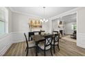 Charming dining room with hardwood floors, elegant chandelier, and stylish furnishings at 1612 Commons Ford Pl, Apex, NC 27539