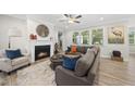 Cozy living room featuring a fireplace, comfortable seating, and ample natural light at 1612 Commons Ford Pl, Apex, NC 27539