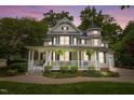 Beautiful two-story home with a spacious front porch and well-manicured landscaping at 1702 Mcrae Pl, Hillsborough, NC 27278