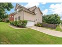 View of home showing a two car garage, landscaped yard and a driveway at 200 Vintage Hill Cir, Apex, NC 27539