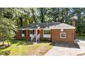 Attractive brick home with a bright red door and traditional white railings at 208 Essex Rd, Nashville, NC 27856