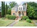 Brick home with manicured landscaping, lovely walkway, and cozy covered front entrance at 2236 The Cir, Raleigh, NC 27608