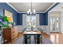 Charming dining room with hardwood floors, a large window, and stylish decor at 230 Paddy Ln, Youngsville, NC 27596