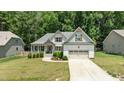 Attractive single Gathering home with inviting front yard landscaping and attached two-car garage at 230 Paddy Ln, Youngsville, NC 27596