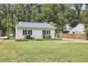 Well-maintained exterior with green grass and a small garden at 2616 Kirk Rd, Durham, NC 27705