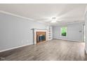 Spacious living room with fireplace, large window, and neutral gray walls at 3 Cobble Glen Ct, Durham, NC 27713