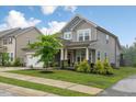 Attractive two-story house with manicured lawn and inviting curb appeal at 304 Avery Glenn Way, Fuquay Varina, NC 27526