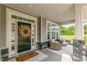Inviting front porch with stylish decor, seating, and a welcoming entrance at 304 Avery Glenn Way, Fuquay Varina, NC 27526