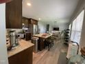 Open kitchen with large island, stainless steel appliances, and adjacent dining and living areas at 305 Briarcliff Dr, Dunn, NC 28334