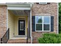 Close-up of the front entrance featuring a black front door and stone facade at 317 Springhurst Ln, Cary, NC 27511