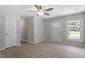 Bright living room features modern ceiling fan, fresh paint, and neutral luxury vinyl plank floors at 3204 Winfield Ct, Raleigh, NC 27610