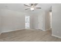 Bright living room features modern ceiling fan, fresh paint, and neutral luxury vinyl plank floors at 3204 Winfield Ct, Raleigh, NC 27610