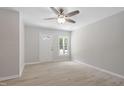 Bright living room features modern ceiling fan, fresh paint, and neutral luxury vinyl plank floors at 3204 Winfield Ct, Raleigh, NC 27610