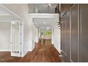 Welcoming foyer featuring hardwood floors, wainscoting, staircase, and light-filled spaces at 344 Colonial Ridge Dr, Pittsboro, NC 27312