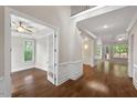 Bright foyer showcasing hardwood floors, wainscoting, and open floor plan with natural light at 344 Colonial Ridge Dr, Pittsboro, NC 27312