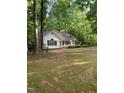 A cozy home nestled among mature trees on a sprawling lot at 352 Riverstone Dr, Clayton, NC 27527