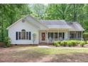 Attractive single-Gathering home with a covered front porch, black shutters, and lush landscaping enhancing curb appeal at 352 Riverstone Dr, Clayton, NC 27527