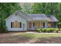 Inviting single-Gathering home featuring a covered porch, black shutters, and mature landscaping for a welcoming appearance at 352 Riverstone Dr, Clayton, NC 27527