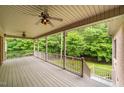 A covered outdoor porch offers serene views, ceiling fans, and a great space for relaxing outdoors at 3994 Limerick Dr, Burlington, NC 27215